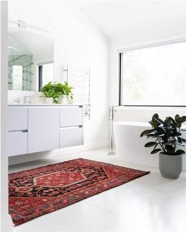 White bathroom with red rug Persian style rug