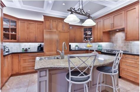 Kitchen with island and white deep coffer ceiling, and cabinets on 3 sided walls
