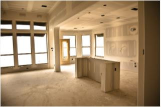 Kitchen space with unfinished drywalls