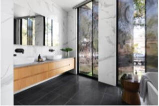 Bathroom with black tile floor, long windows, long vanity
