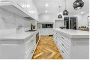 White kitchen with white cabinets and drop 3 lights on island