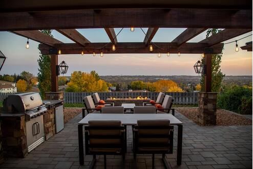 Beautiful Pergola with overhanging lighting; table and grill. 