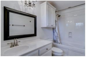 White remodel bathroom with black mirror